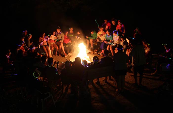 Crowd of people around a camp fire